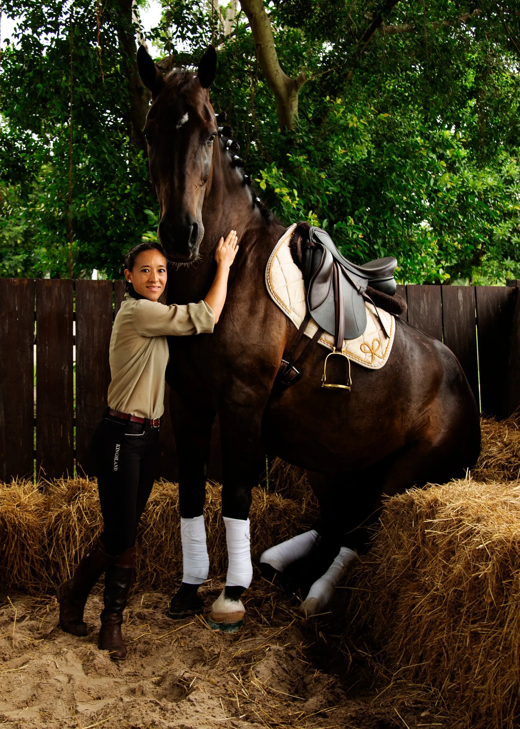 A rider with her horse, fitted in a cream and gold IDEAL dressage saddle